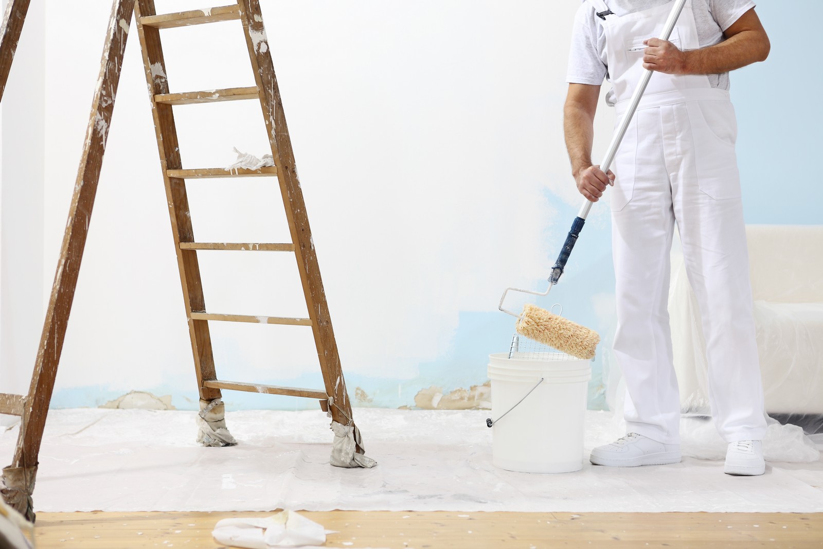 painter,man,at,work,with,a,paint,roller,and,ladder,